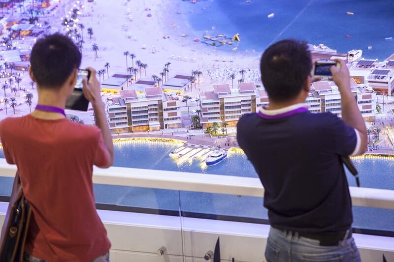 Visitors take photos of the La Mer development by Meraas Holding. Antonie Robertson / The National