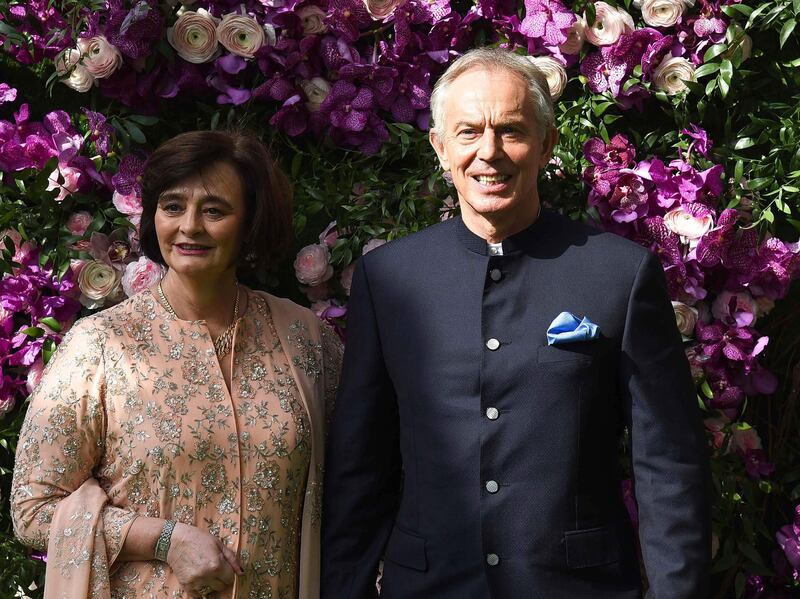 Former British prime minister Tony Blair (R) and his wife Cherie Blair (L) pose for photographs as they arrive to attend the wedding ceremony of Akash Ambani, son of Indian Businessman Mukesh Ambani, in Mumbai on March 9, 2019. / AFP / SUJIT JAISWAL
