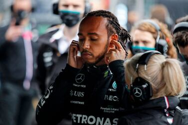 Mercedes' British driver Lewis Hamilton gets ready with his team prior to the start of the Formula One Grand Prix of Turkey at the Intercity Istanbul Park in Istanbul on October 10, 2021.  (Photo by UMIT BEKTAS  /  POOL  /  AFP)