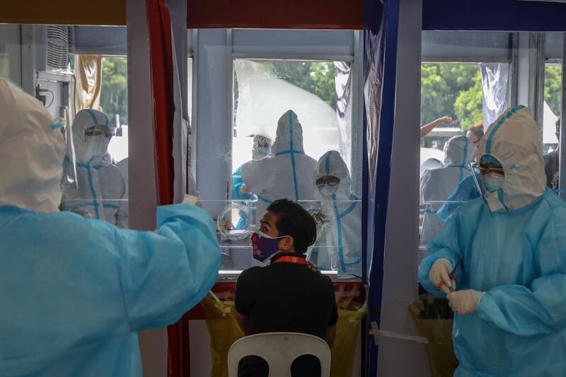 Health workers perform swab tests to government workers in Quezon City, northeast of Manila, Philippines. EPA