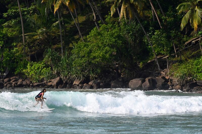 6. A tourist surfs along a beach in Mirissa, Sri Lanka. AFP