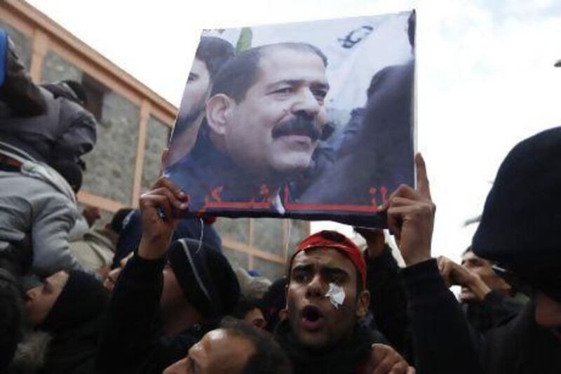 Mourners hold a placard of Chokri Belaid during his funeral procession in Tunis February. Anis Mili / Reuters