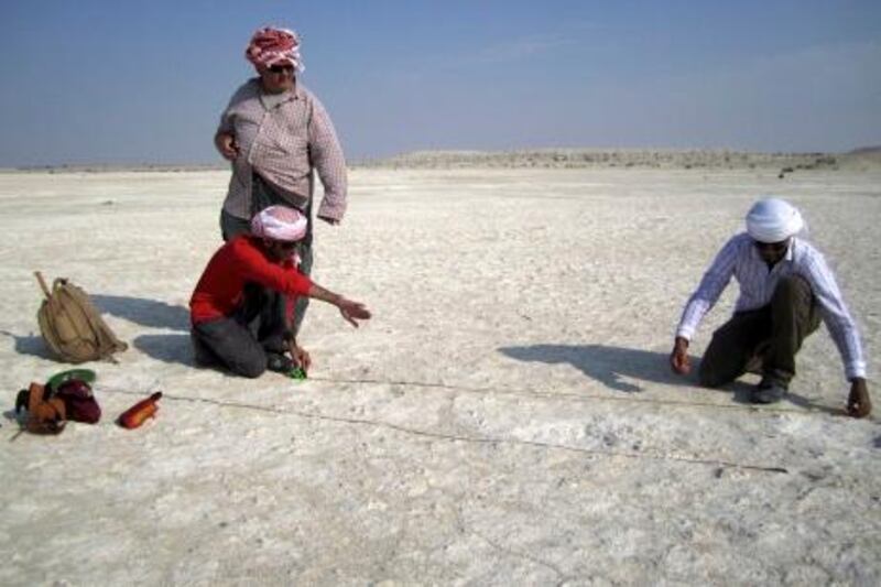 Abdulla Al Kaabi, Abdul Rahman Al-Nuaimi (left, right) and co-author Mark Beech (standing) acquiring field measurements at Mleisa 1 (10 Jan 2011). Photographer and © Faysal Bibi. For elephant footprint discovery story in National 