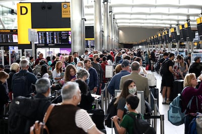 Passengers queue inside the departures terminal of Terminal 2 at Heathrow airport. Reuters