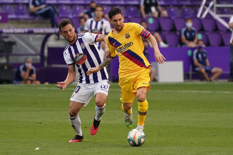 Real Valladolid's Spanish midfielder Oscar Plano battles with Lionel Messi. AFP