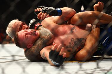 May 7, 2022; Phoenix, Arizona, USA; Charles Oliveira applies a hold for the submission victory against Justin Gaethje during UFC 274 at Footprint Center.  Mandatory Credit: Mark J.  Rebilas-USA TODAY Sports