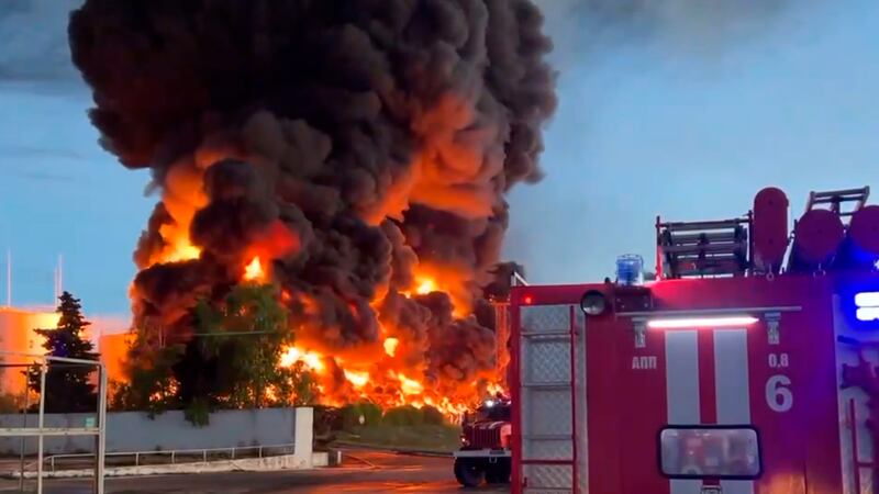 Flames rise from a burning fuel tank at a depot in the Crimean port city of Sevastopol on Saturday. AP