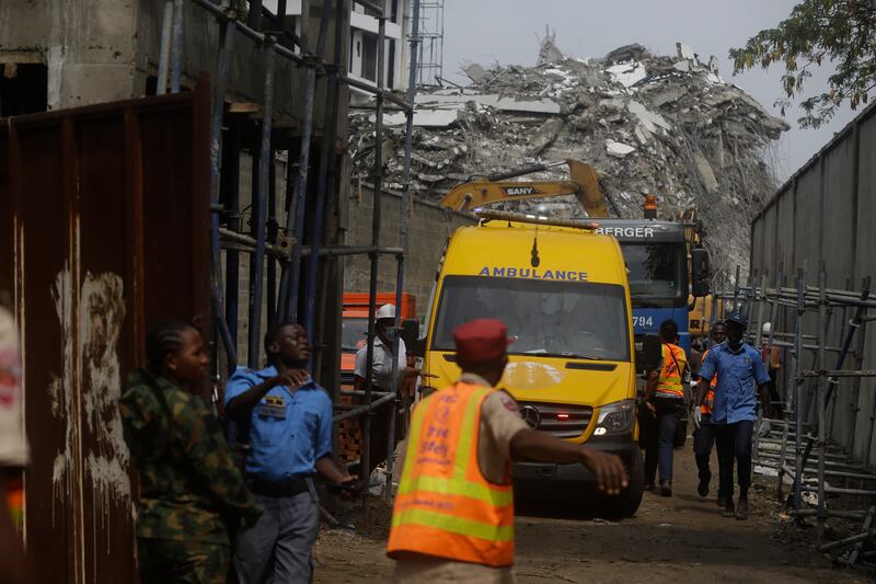 Rescue workers gather around an ambulance with a survivor who was found in the rubble. AP