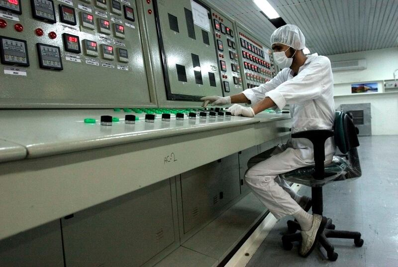 FILE - In this Feb. 3, 2007 file photo, an Iranian technician works at the Uranium Conversion Facility just outside the city of Isfahan, Iran, 255 miles (410 kilometers) south of the capital Tehran. Iran says it restarted the production facility in Isfahan, a "major" uranium facility involved in its nuclear program, but still pledges to follow the terms of its atomic deal now threatened by President Donald Trump pulling America from the accord. (AP Photo/Vahid Salemi, File)