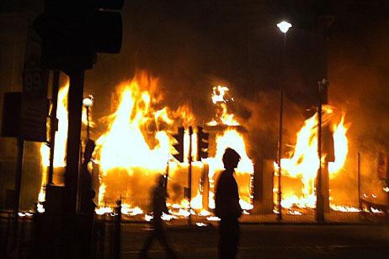 A shop in the Tottenham area of London burns after being set alight by youths protesting against the killing of a man by armed police last Thursday.