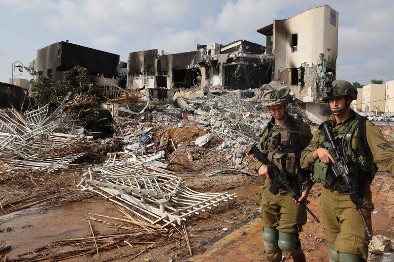 Soldiers walk past an Israeli police station damaged during battles to dislodge Hamas militants who were stationed inside. AFP