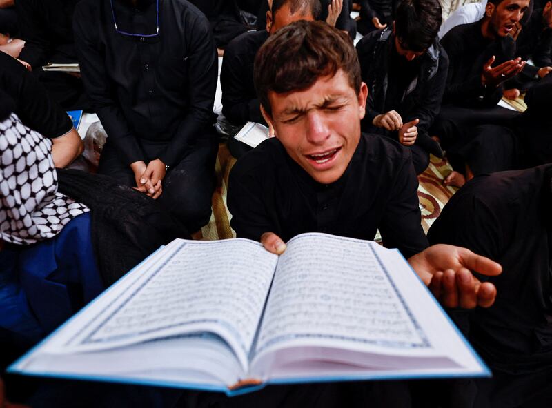 A Muslim man prays on the anniversary of Imam Ali's death
