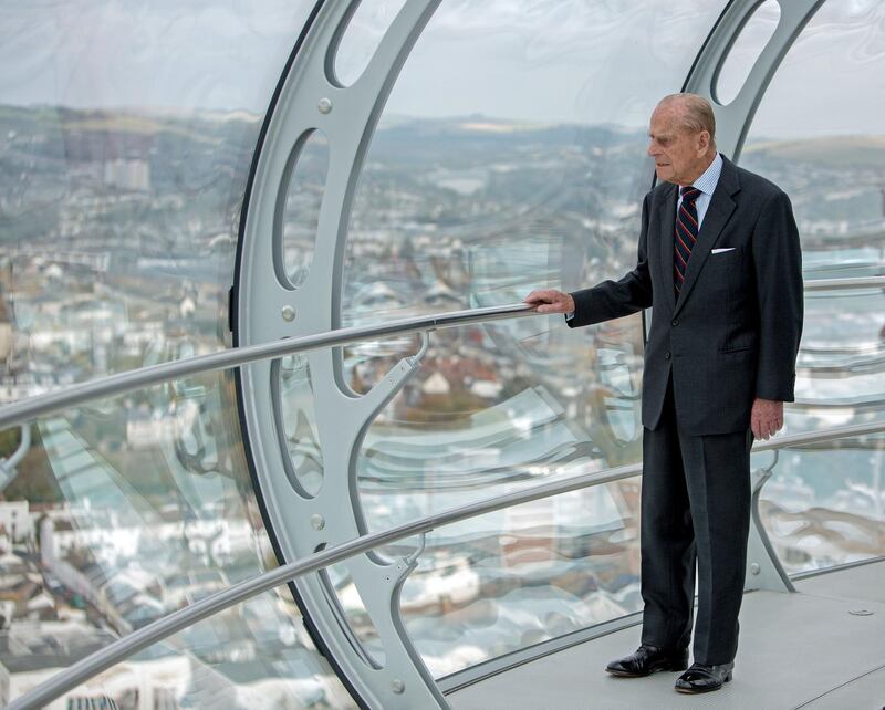 BRIGHTON, ENGLAND - OCTOBER 28: Prince Philip, Duke of Edinburgh  looks out onto the seafront during his visit to the British Airways i360 attraction in Brighton, East Sussex where he took a ride on the world's first vertical cable car on October 28, 2016 in Brighton, United Kingom. The futuristic-looking structure opened on August 4 and is the world's tallest moving observation tower, standing where the wrecked Grade I-listed West Pier, built in 1866, joined the seafront promenade. (Photo by Steve Parsons - WPA Pool/Getty Images)