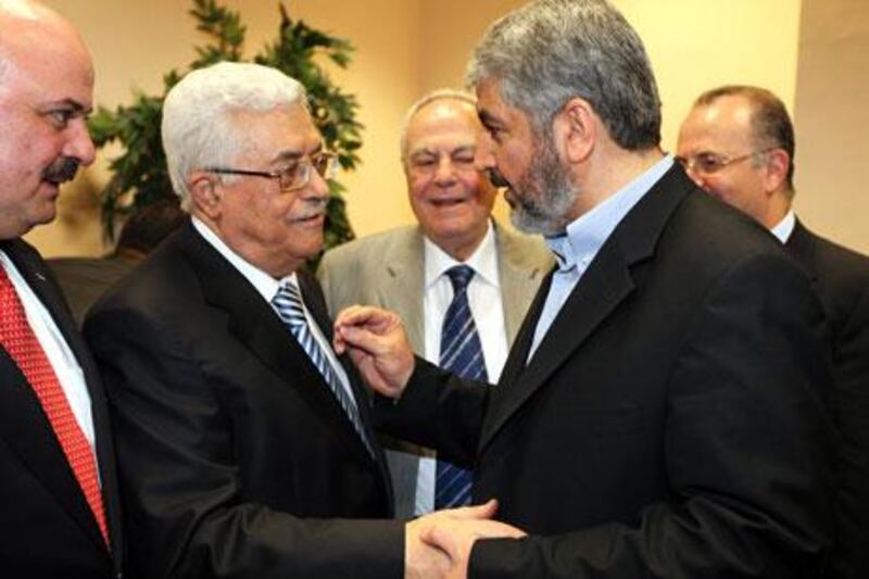 The Palestinian president Mahmoud Abbas, left, shakes hands with the Hamas leader Khaled Meshaal during a ceremony in Cairo this May that marked a warming of relations between the factions.