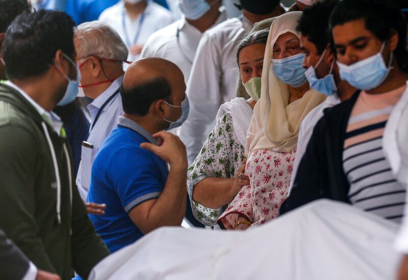 Dilip Kumar's wife Saira Banu, centre, with the actor's body at a hospital in  Mumbai on Wednesday.