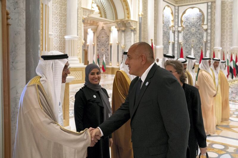 ABU DHABI, UNITED ARAB EMIRATES - October 21, 2018: HE Zaki Anwar Nusseibeh, UAE Minister of State (L), greets HE Boyko Borissov, Prime Minister of Bulgaria (3rd L), during a reception at the Presidential Palace. Seen with HE Ohood Al Roumi, UAE Minister of State for Happiness and Wellbeing (2nd L)

( Hamad Al Kaabi / Crown Prince Court - Abu Dhabi )
---