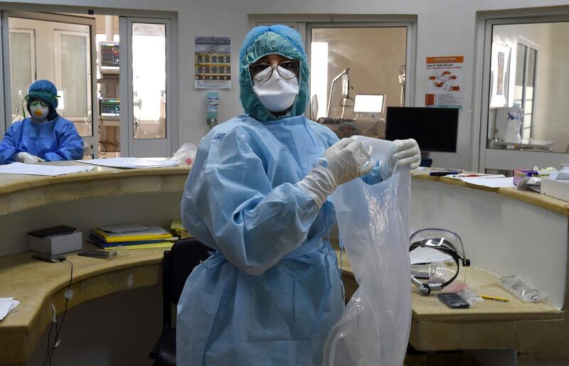 Members of the medical staff of the Ariana Mami hospital, where patients of Covid-19 are being treated, work at the special care unit, in the city of Ariana near the Tunisian capital Tunis on April 22, 2020, during the novel coronavirus pandemic crisis. 
 / AFP / FETHI BELAID
