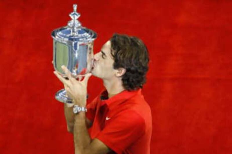 Roger Federer of Switzerland kisses the trophy after beating Andy Murray of Britain for his fifth straight US Open tennis title at Flushing Meadows in New York on Sept 8, 2008.