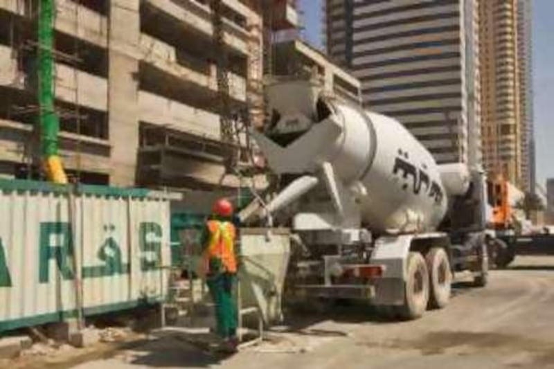 Ready mixed concrete truck fills crane skip during the construction of a high rise tower block.  Dubai. United Arab Emirates.  <br>Model Release: No <br>Property Release: No<br>[Photo via Newscom] (Newscom TagID: scphotos033994)