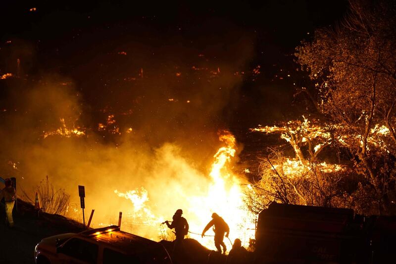 Local emergency officials warned of powerful winds  that will feed wildfires raging in Los Angeles, threatening multi-million dollar mansions.   Sandy Huffaker / AFP Photo