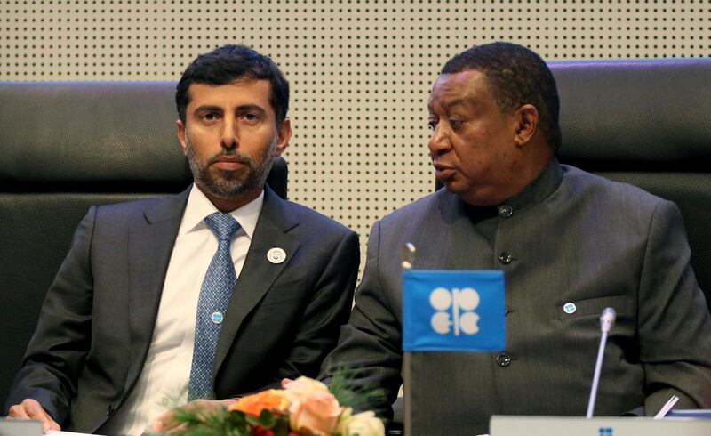 Minister of Energy of the United Arab Emirates, UAE, Suhail Mohamed Al Mazrouei talks with Mohammad Sanusi Barkindo, from left, OPEC Secretary General of Nigeria prior to the start of a meeting of the Organization of the Petroleum Exporting Countries, OPEC, at their headquarters in Vienna, Austria, Thursday, Dec. 6, 2018. (AP Photo/Ronald Zak)