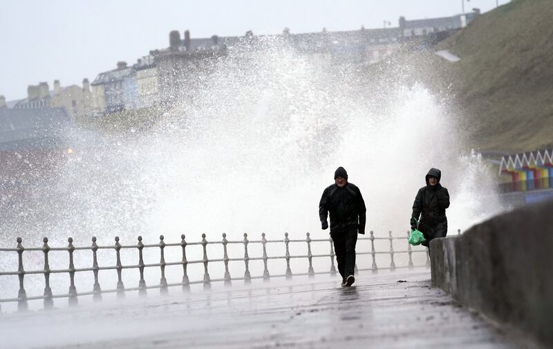 Big waves hit the sea wall at Whitby in Yorkshire. Storm Eunice was expected to bring strong winds and the possibility of snow on Friday. PA