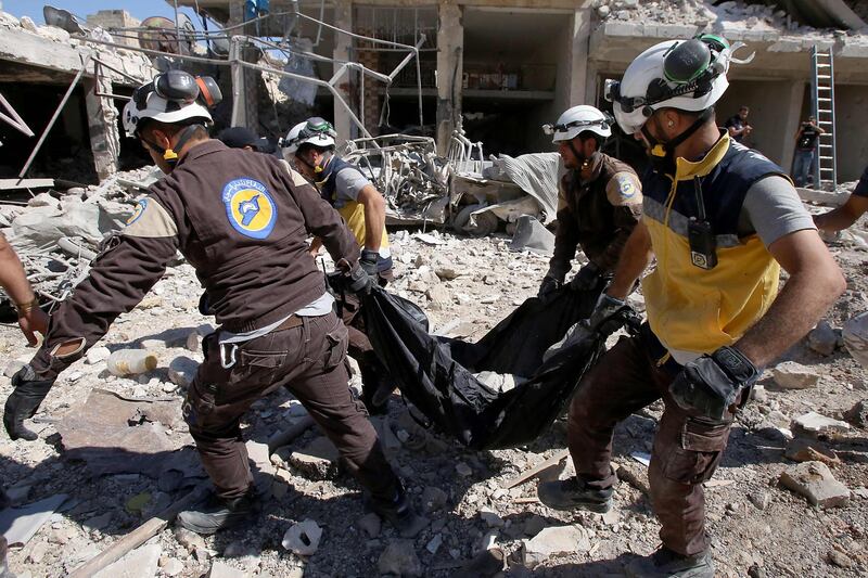 The Syrian White Helmets carry away an injured man. AFP