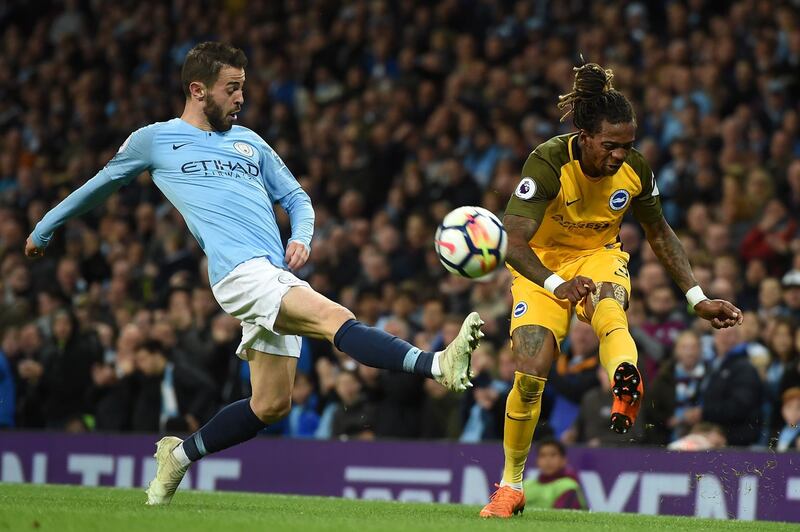 Manchester City's Portuguese midfielder Bernardo Silva (L) vies with Brighton's Cameroonian defender Gaetan Bong during the English Premier League football match between Manchester City and Brighton and Hove Albion at the Etihad Stadium in Manchester, north west England, on May 9, 2018. (Photo by Paul ELLIS / AFP) / RESTRICTED TO EDITORIAL USE. No use with unauthorized audio, video, data, fixture lists, club/league logos or 'live' services. Online in-match use limited to 75 images, no video emulation. No use in betting, games or single club/league/player publications. / 