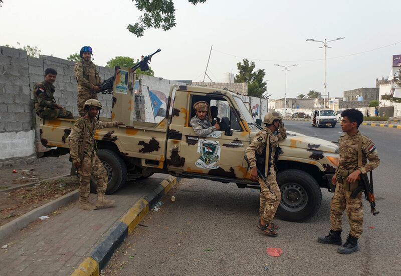 Fighters affiliated with Yemen's separatist Southern Transitional Council at the site of an explosion in Aden. AFP