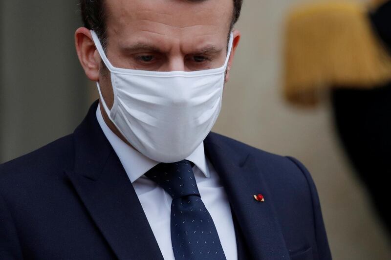 French President Emmanuel Macron, wearing a protective face mask, accompanies Interim Malian President Bah Ndaw (not seen) after a meeting at the Elysee Palace in Paris, France, January 27, 2021. REUTERS/Gonzalo Fuentes