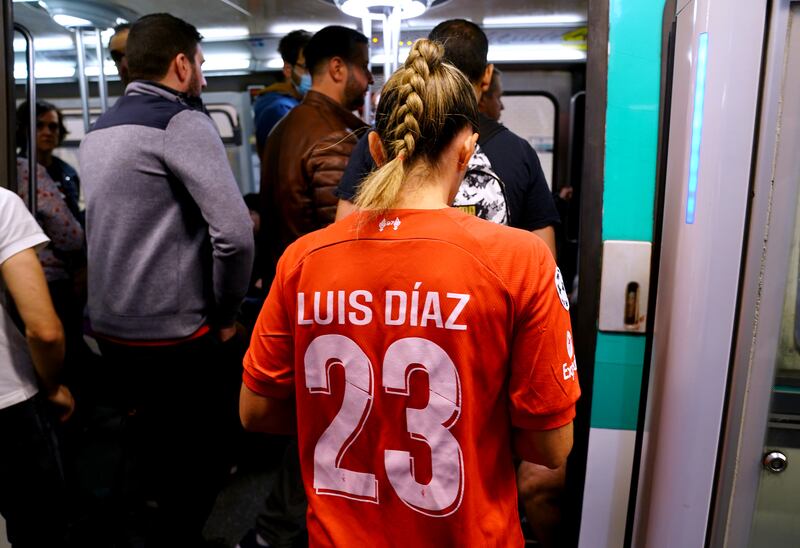 A Liverpool fan gets on the metro ahead of the Champions League Final at the Stade de France, Paris. PA