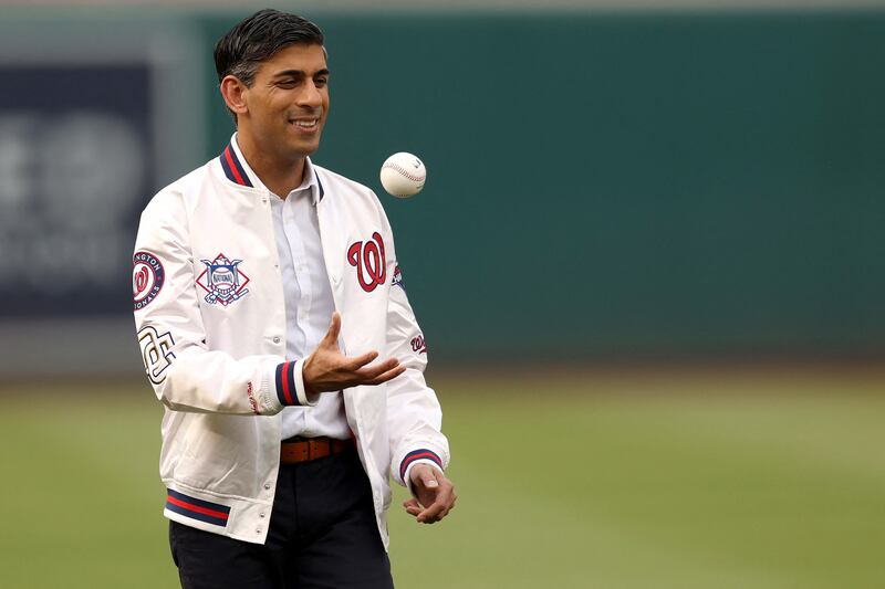 Rishi Sunak tosses a baseball in the air after being introduced before the start of the Washington Nationals and Arizona Diamondbacks game. AFP