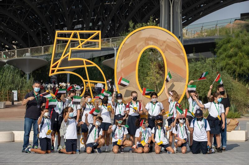 Young visitors pose in front of one of the installations at Expo 2020 in celebration of the UAE's Golden Jubilee. Image: Expo 2020 Dubai