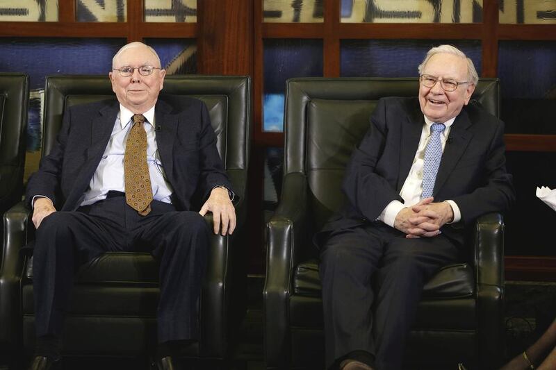 Berkshire Hathaway chairman and CEO Warren Buffett, right, laughs with Berkshire Hathaway vice chairman Charlie Munger. Nati Harnik / AP Photo