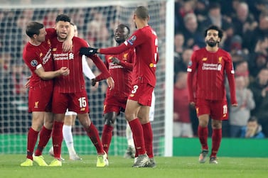 Liverpool's Alex Oxlade-Chamberlain celebrates with teammates after scoring  the winner against Genk in their Champions League group game at Anfield. Getty