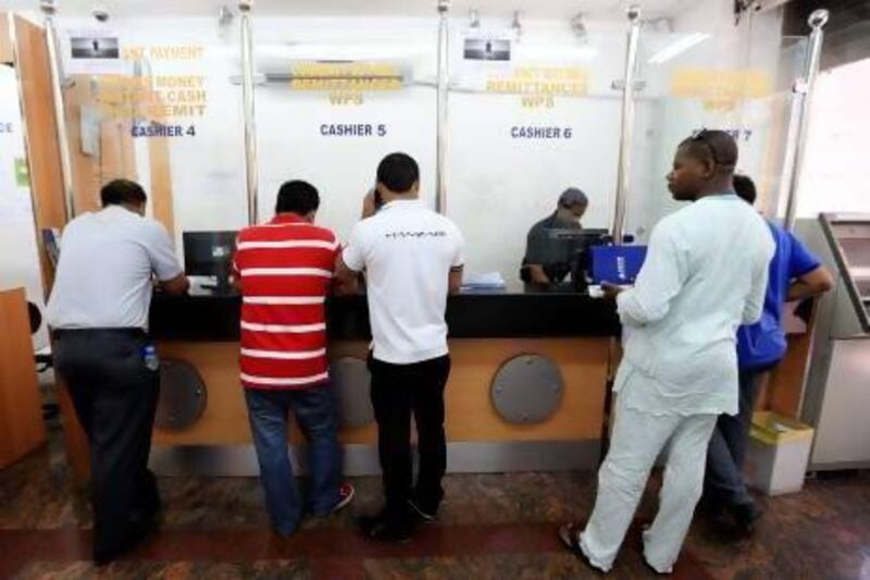 Customers queue at GCC Exchange in Deira, Dubai. Currency appreciation is squeezing the finances of thousands of expatriate workers across the Emirates. Sarah Dea / The National