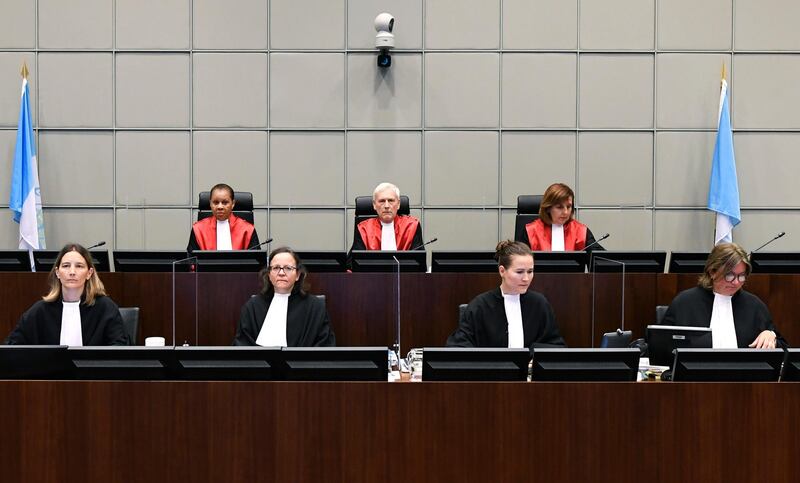 Presiding Judge, Judge David Re, top centre, with Judge Janet Nosworthy, left, and Judge Micheline Braidy, during a session of the United Nations-backed Lebanon Tribunal in Leidschendam, Netherlands Tuesday Aug. 18, 2020, where it is scheduled to hand down it's judgement in the case against four men being tried for the bombing that killed former Lebanon Prime Minister Rafik Hariri and 21 others.  The U.N.-backed tribunal in the Netherlands is to deliver verdicts in the trial held in absentia of four members of the militant Lebanese Hezbollah group accused of involvement in the 2005 truck bomb assassination of former Lebanese Prime Minister Rafik Hariri. (Piroschka Van De Wouw/Pool via AP)