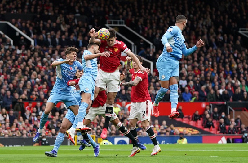 Manchester United defender Harry Maguire, centre, heads the ball. AP