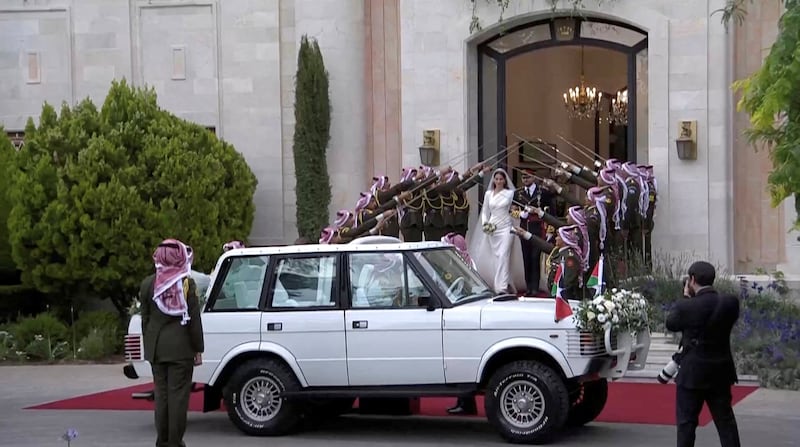 Prince Hussein and Princess Rajwa leave after the wedding ceremony. Reuters