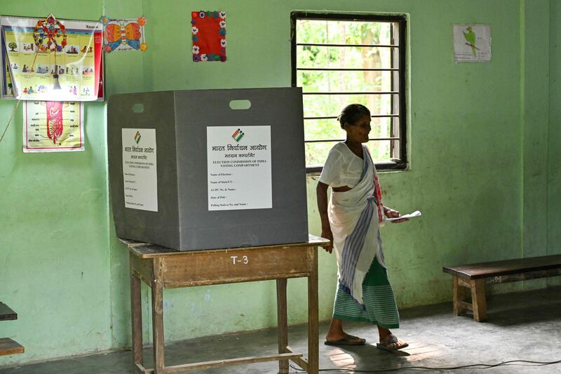 A woman leaves after casting her ballot at a polling station in Kuwaritol village, Assam state. AFP