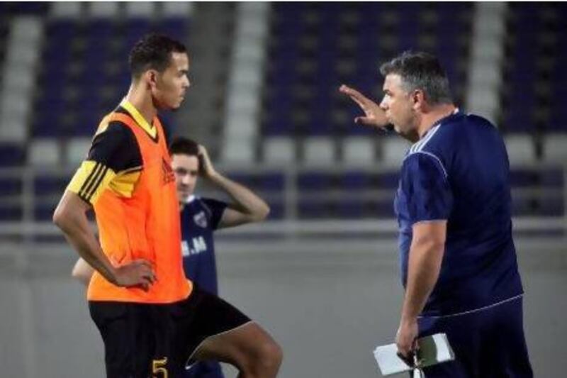 Al Ain coach Cosmin Olaroiu talks to defender Ismail Ahmed. Silvia Razgova / The National