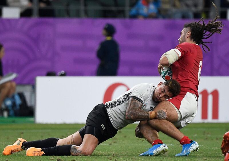 Wales' flanker Josh Navidi (R) is tackled by Fiji's centre Jale Vatubua  during the Japan 2019 Rugby World Cup Pool D match between Wales and Fiji at the Oita Stadium in Oita. AFP