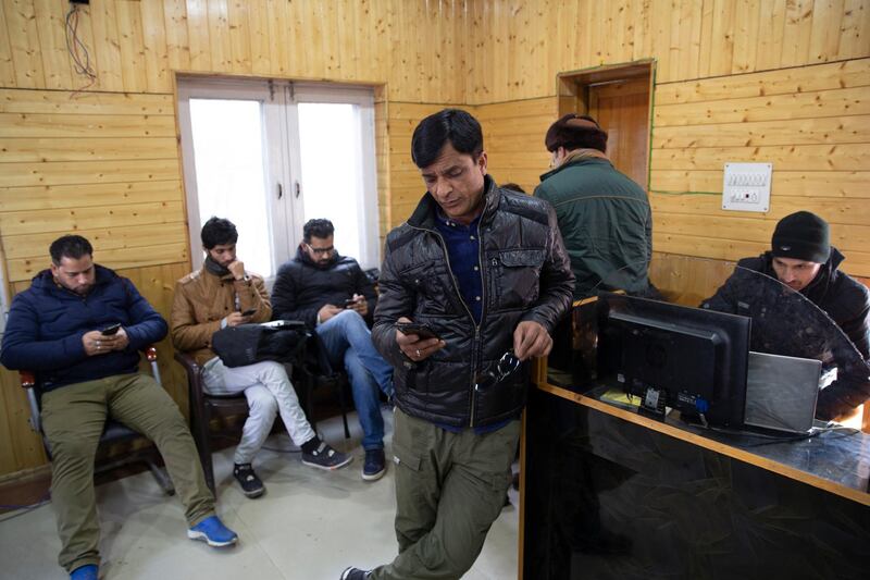 FILE - In this Jan. 30, 2020, file photo, Kashmiri journalists browse the internet on their mobile phones inside the media center set up by government authorities in Srinagar, Indian controlled Kashmir. India ended an 18-month-long ban on high speed internet services on mobile devices in disputed Kashmir, where opposition to New Delhi has deepened after it revoked the region's semi-autonomy. The order late Friday, Feb. 5, lifted the ban on 4G mobile data services However, the order issued by the regionâ€™s home secretary, Shaleen Kabra, asked police officials to â€œclosely monitor the impact of lifting of restrictions.â€  (AP Photo/Dar Yasin, File)