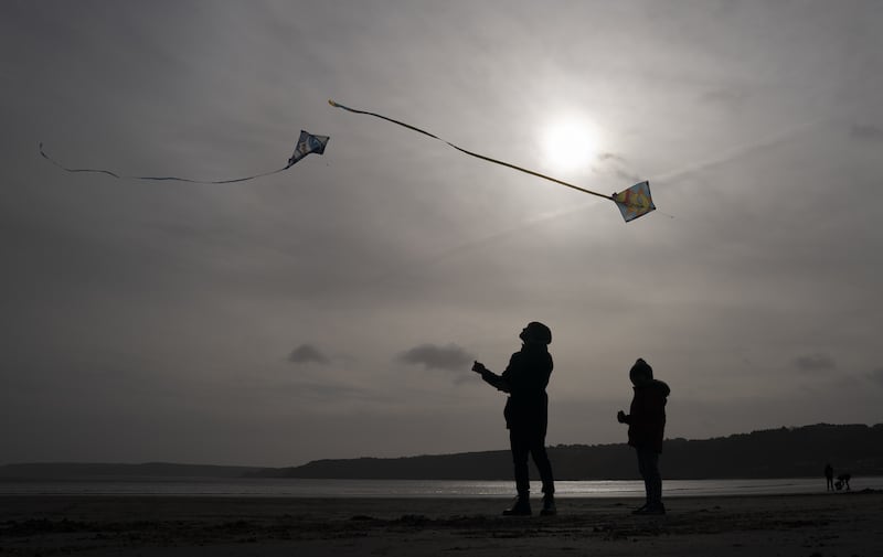People take advantage of the winds and fly Kites on Scarborough beach in North Yorkshire. PA