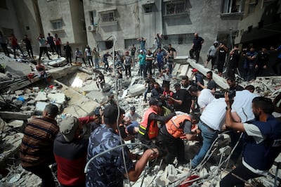 Search and rescue works are conducted at debris of a building after airstrikes by Israeli army hit buildings in al-Rimal neighborhood of Gaza City, Gaza on May 16, 2021. Majd Mohamad