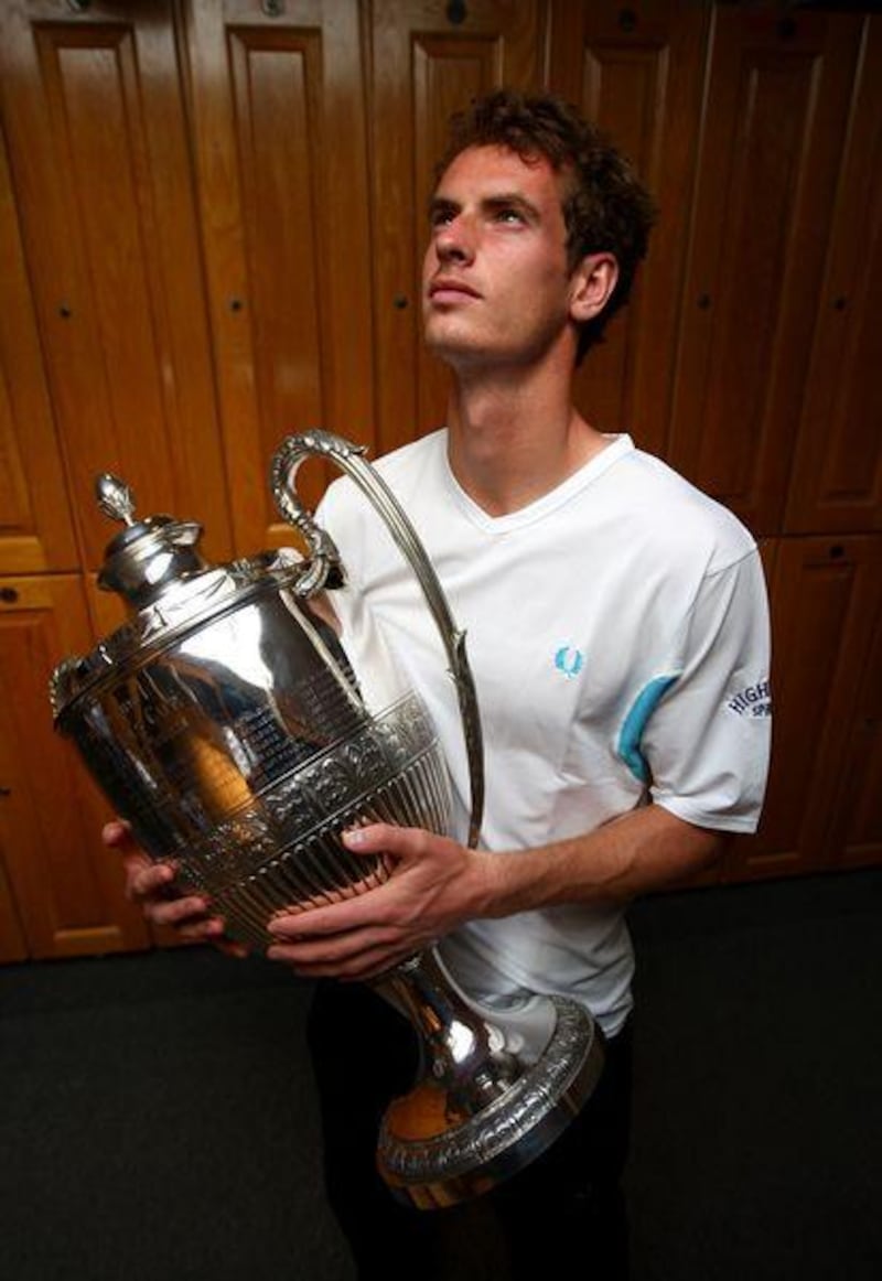 Andy Murray proudly holds the AEGON Championship trophy after  beating James Blake in the final at Queens Club in London last week.