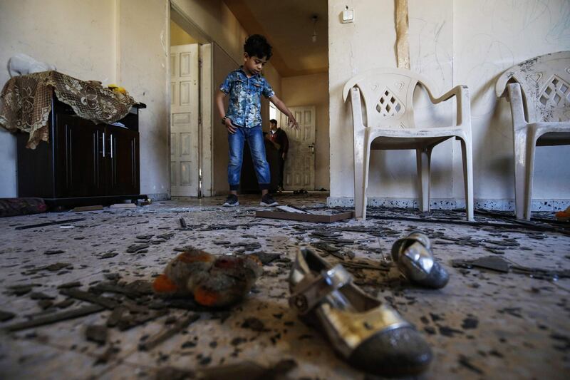 A Palestinian boy enters his family's damaged apartment in Rafah in the southern Gaza strip. AFP