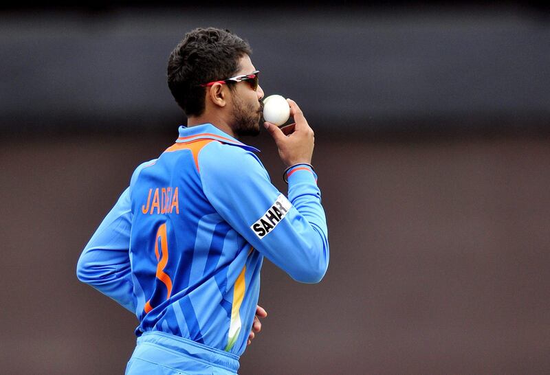 India's Ravindra Jadeja kisses the ball after catching out West Indies' Dwayne Bravo for 25 runs during the 2013 ICC Champions Trophy cricket match between India and West Indies at The Oval in London on June 11, 2013. AFP PHOTO/GLYN KIRK  == RESTRICTED TO EDITORIAL USE  ==
 *** Local Caption ***  316896-01-08.jpg