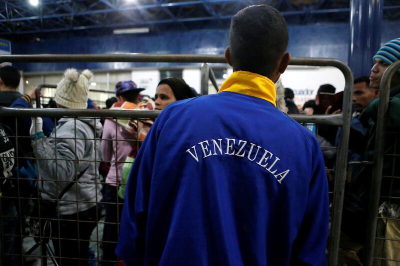 Venezuelan migrants stand in line to register their entry into Ecuador at the Rumichaca International Bridge in Ecuador. Reuters