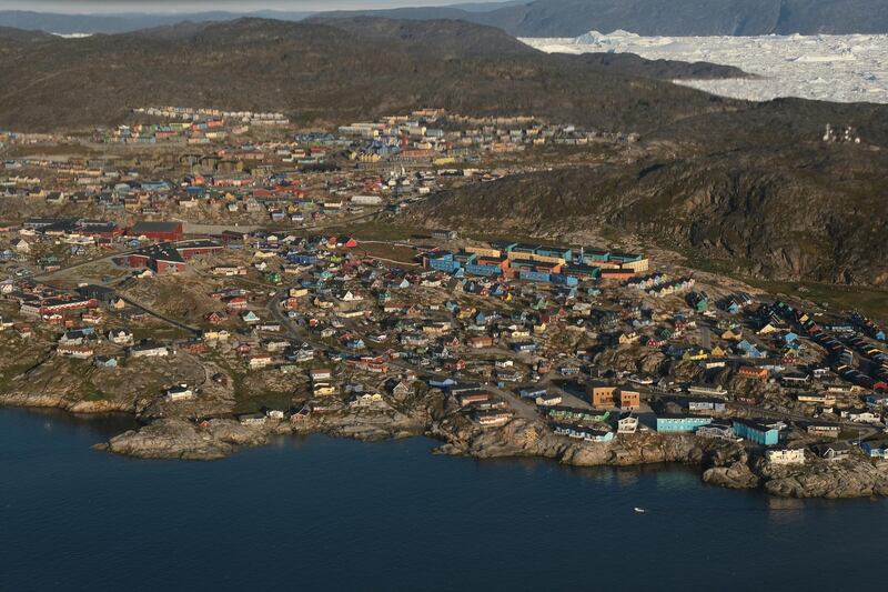 ILULISSAT, GREENLAND - AUGUST 04: In this view from an airplane the town of Ilulissat is seen on Disko Bay on August 04, 2019 in Ilulissat, Greenland. As the Earth's climate warms summers have become longer in Ilulissat, allowing fishermen a wider period to fish from boats on open waters and extending the summer tourist season. Long term benefits are uncertain, however, as warming waters could have a negative impact on the local fish and whale population.  (Photo by Sean Gallup/Getty Images)